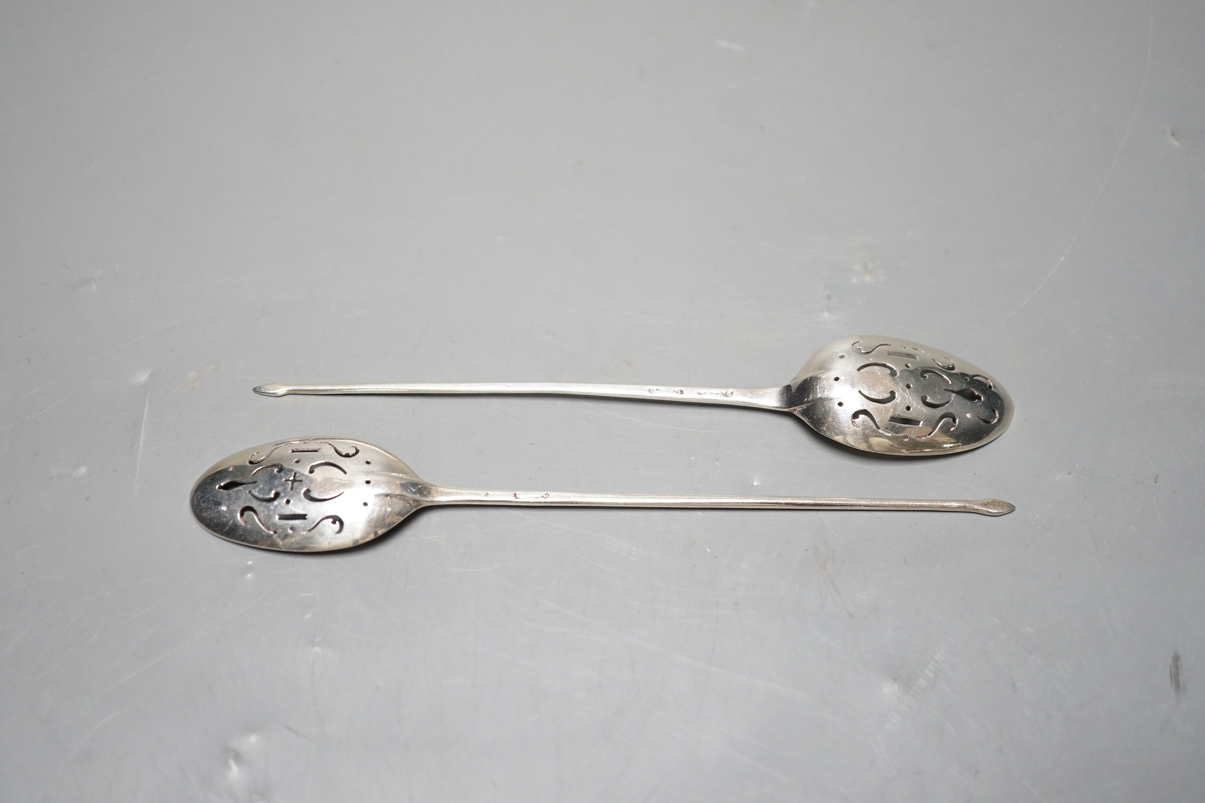Two 18th century silver mote spoons, including one by Nicholas Hearnden, London, circa 1760, 14.5cm, marks rubbed on the other spoon.